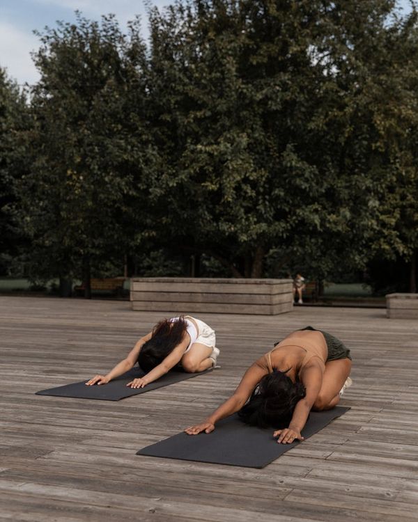 Woman in a calm yoga pose, embodying balance and grace.